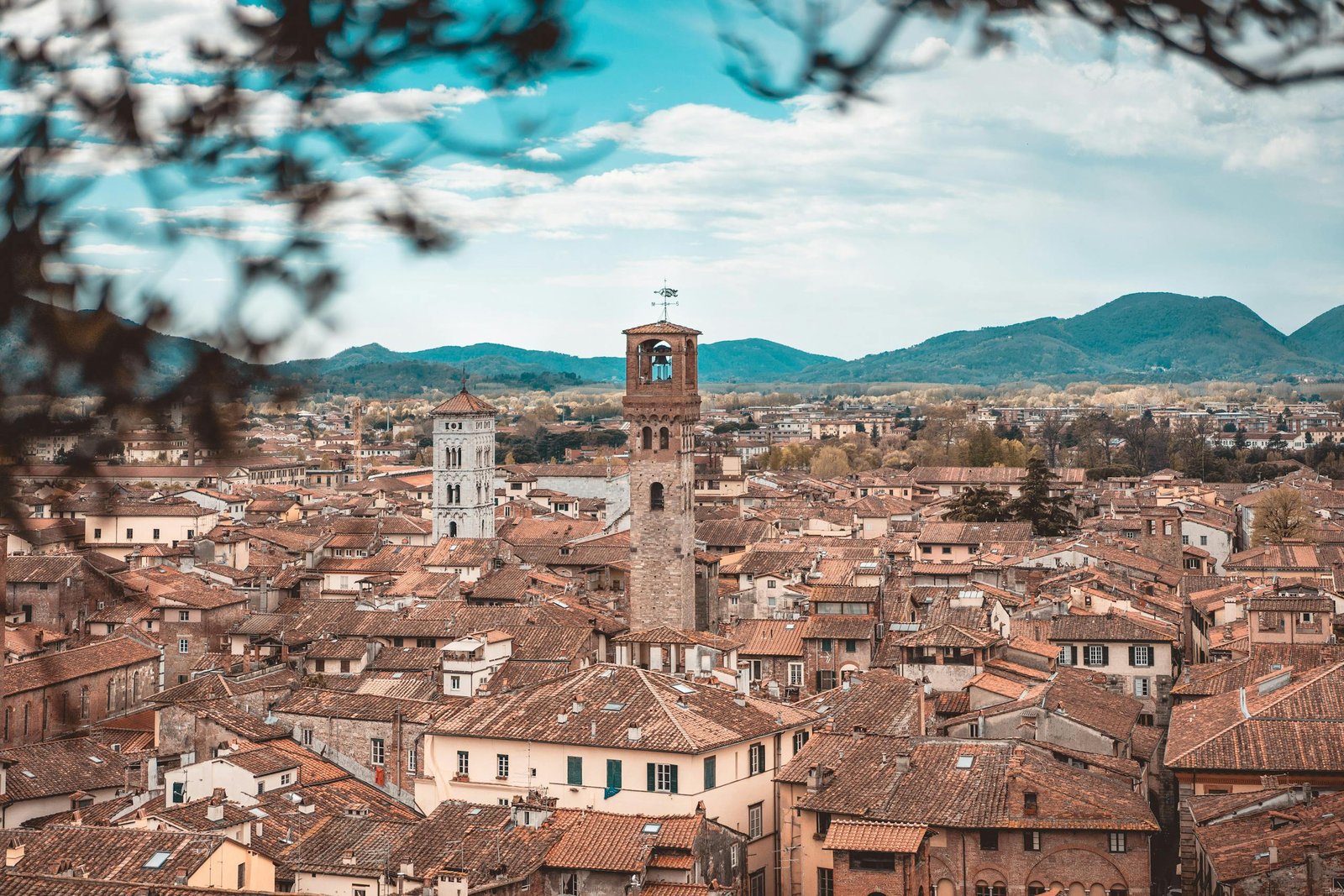 Charming aerial view of Lucca's historic buildings and clock towers in Tuscany.